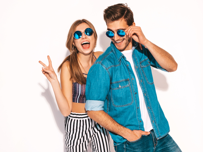 Portrait of Smiling Beautiful Girl and her Handsome Boyfriend laughing.Happy Cheerful Family in sunglasses.Valentine’s Day. Isolated on white. Hugging