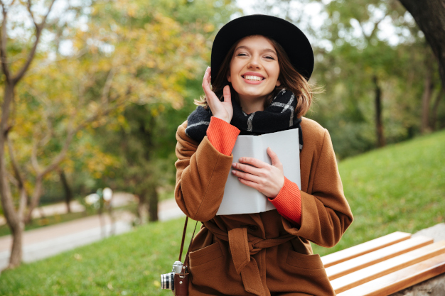 Portrait of a laughing girl dressed in autumn coat